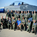 Airmen from the 62nd Fighter Squadron with shaved heads pose March 7 in front of an F-16 Fighting Falcon on the flightline. The Airmen shaved their heads to show support for the son of a deceased 62nd FS pilot who is battling cancer. (U.S. Air Force photo/Senior Airman David Owsianka)