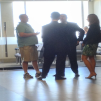 Plaintiff Shaun McClusky talks with attorneys